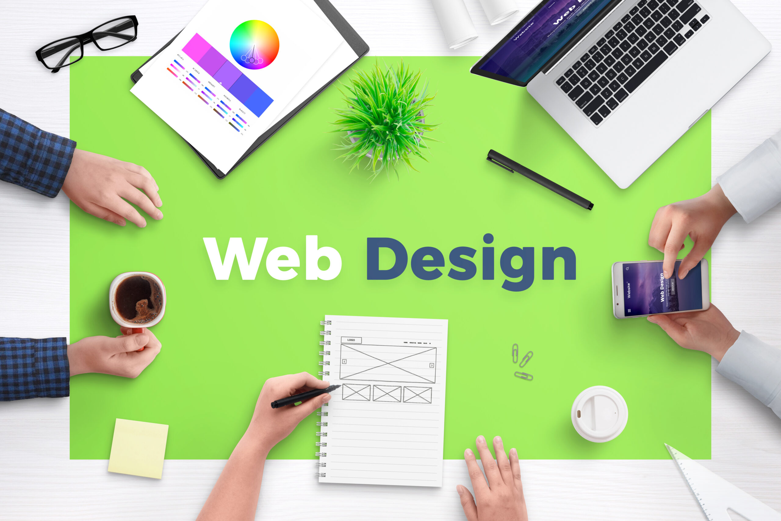 Web design text on office desk. Concept of web development team work space. Flat design flat page on laptop and smart phone.